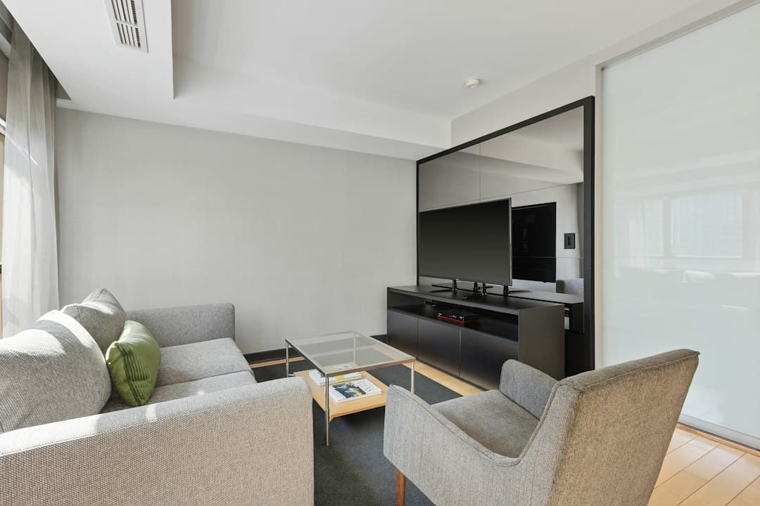 A modern living room with a large flat-screen television, the kind of screen used for Pixlar8k 4K IPTV