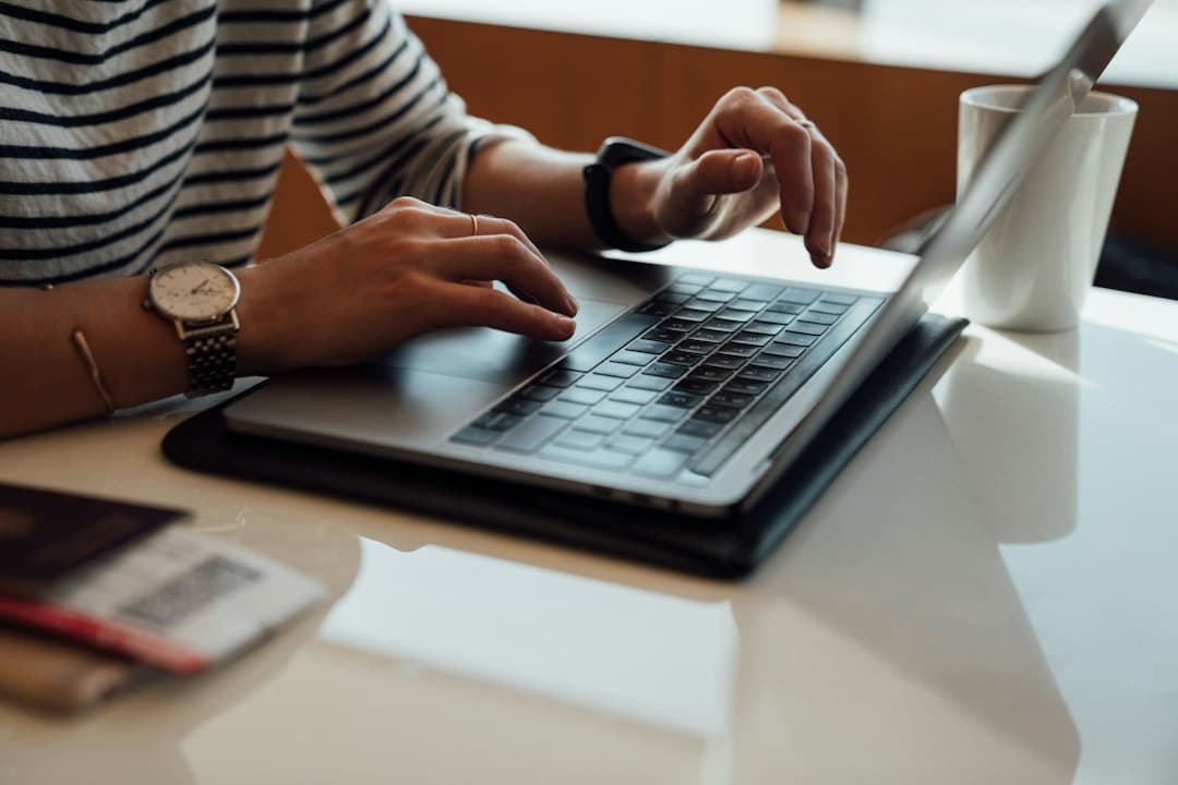 Hands typing on a laptop, entering Pixlar8k M3U playlist or Xtream Codes login details